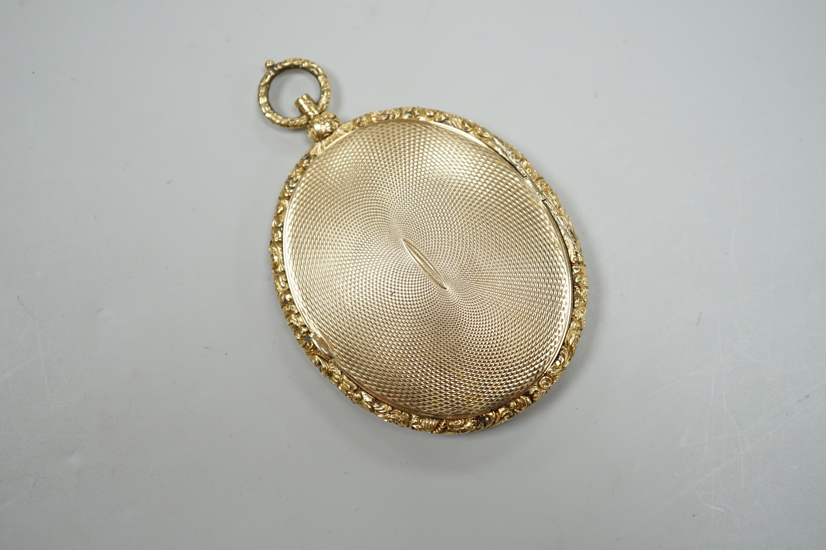 A Victorian engine turned yellow metal (tests as 9ct gold) oval pendant locket, housing a miniature on ivory depicting a lady, overall 7.75cm, gross 41 grams CITIES Submission reference, TVTSSFBX